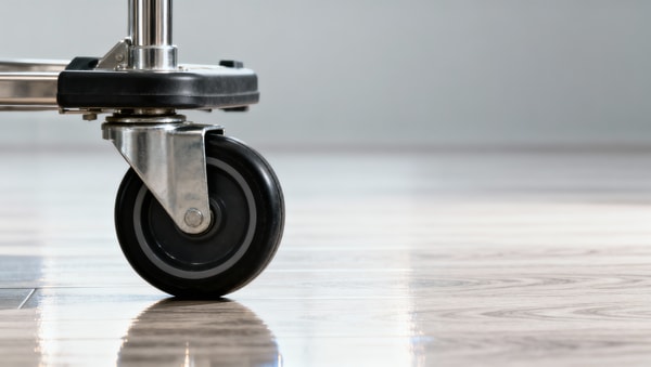 Hospital furniture casters locking up on vinyl floors—wheel material vs. floor finish mismatch
